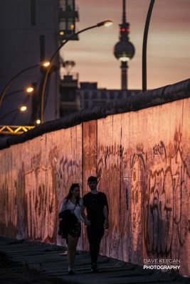 Couple strolling beside The Berlin Wall